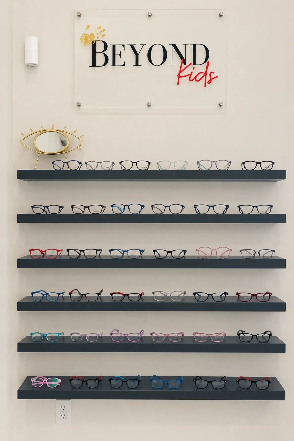 The Beyond Kids frame wall: shelves of colorful children's glasses frames under a Beyond Kids sign
