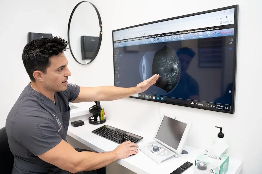 Dr. Tumolo reviewing a patient's eye scan