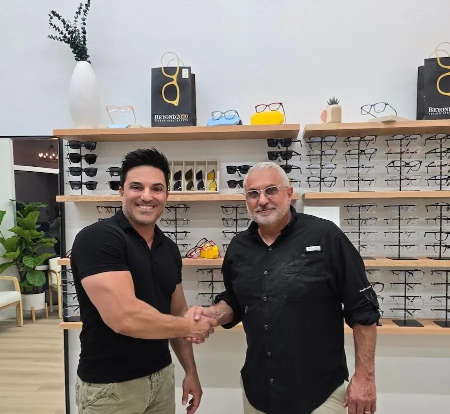 Dr. Tumolo and Dr. Hatala shaking hands in the optical